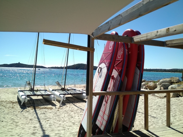  Stand Up Paddle boards and sailboats at the water's edge 