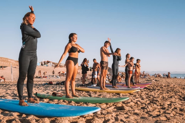  Surf lesson stretching on the beach 