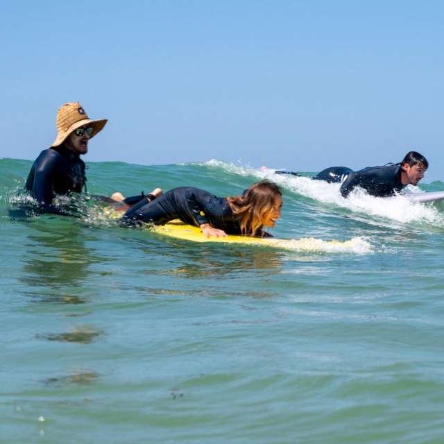  Surf instructor helping his students 