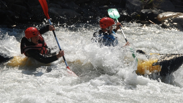  Two people paddling while rafting 