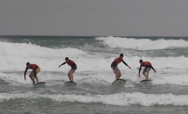 Several surfers on the waves. 