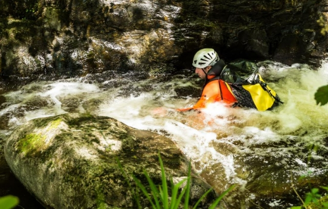 Passage through a rapid in canyoning 