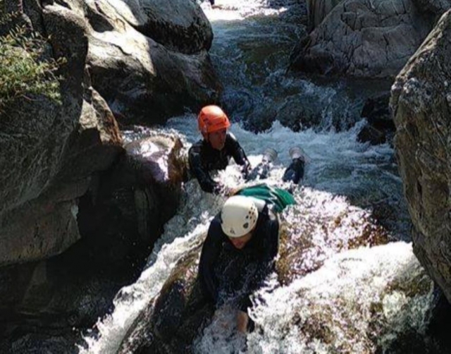  Sliding in the rapids during a canyoning session