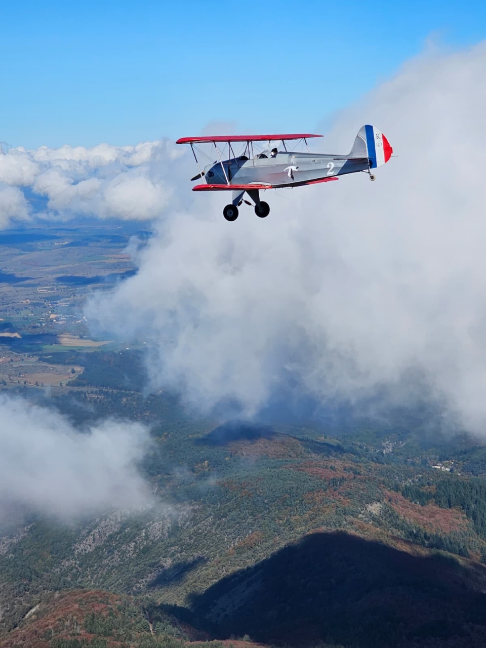  Flying over the mountains aboard a retro two-seater plane 