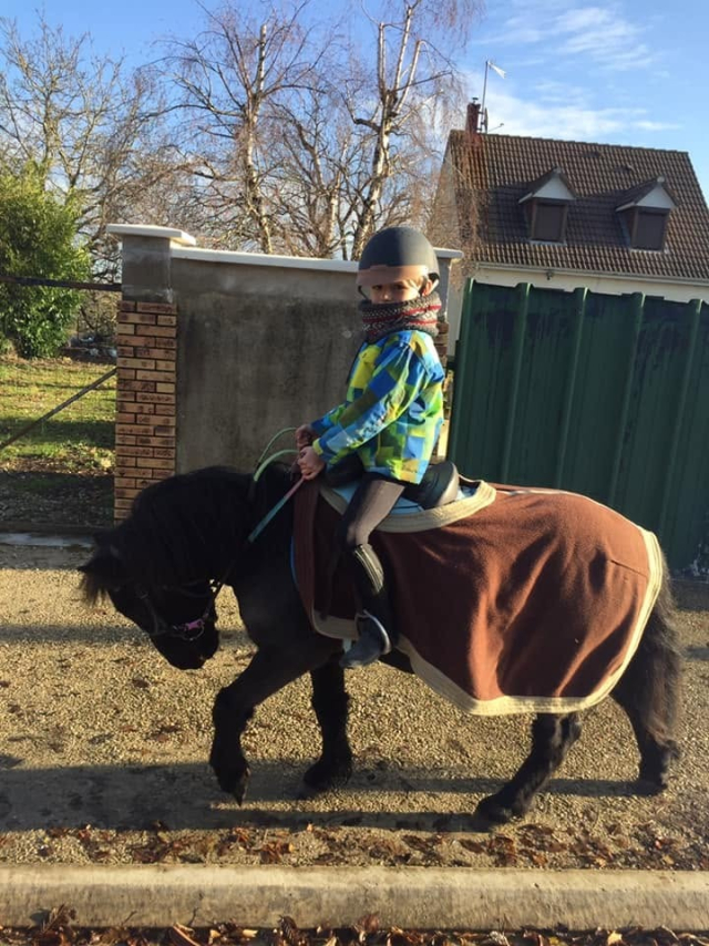  Little rider on his pony, with the blanket